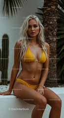 Blonde Woman Relaxing in Yellow Bikini in Tropical Setting