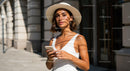 Stylish Woman in White Dress Using Smartphone Outdoors