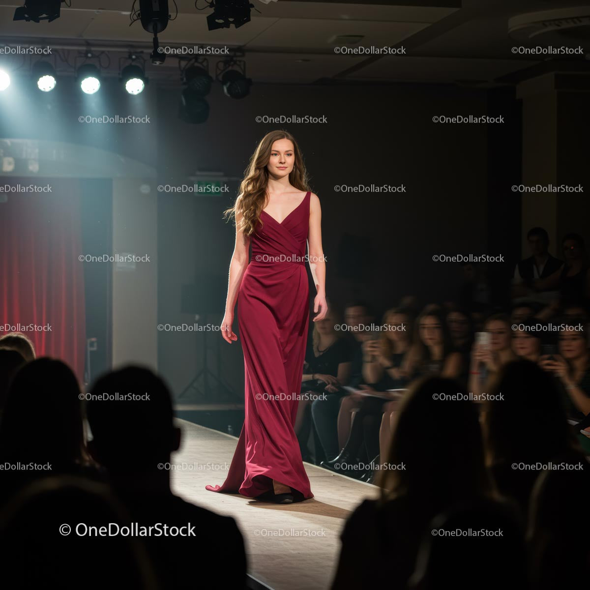 Elegancka modelka spacerująca w czerwonej sukni wieczorowej po wybiegu