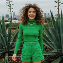Smiling Woman in Green Outfit Among Agave Plants
