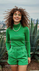 Joyful Woman in Green Outfit with Curly Hair Outdoors