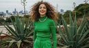 Cheerful Woman in Green Amongst Urban Agave Plants