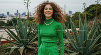 Cheerful Woman in Green Amongst Urban Agave Plants
