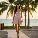 Woman in Pink Dress Strolling on Tropical Beach at Sunset