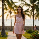 Elegant Woman Strolling at Sunset Among Palm Trees