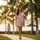 Woman in Pink Dress Strolling Through Tropical Paradise