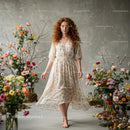 Red-Haired Woman in Floral Dress Among Blossoms