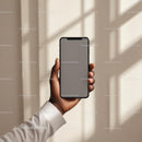 Hand Holding Smartphone in Minimalistic Setting