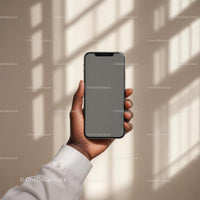 Hand Holding Smartphone with Blank Screen in Sunlit Room