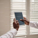 Person Holding Tablet Near Window Blinds