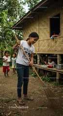Joyful Village Scene with Children Playing and Girl Sweeping