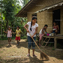 Children Playing and Helping at a Traditional Bamboo House