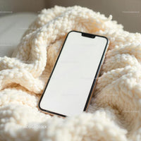 Smartphone on Cozy Knitted Blanket in Soft Light