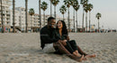 Happy Couple Laughing on a Beach with Palm Trees