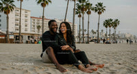 Couple Enjoying a Relaxing Beach Day by Cityscape