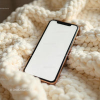 Smartphone Resting on Cream Knitted Blanket