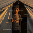 Young Boy Standing at Tent Entrance During Golden Hour