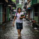 Schoolgirl Braving Rainy Streets in Urban Setting