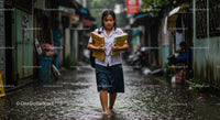 Determined Schoolgirl Walks Through Flooded Street in Rain