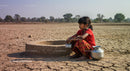Young Girl in Traditional Dress in Arid Landscape