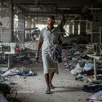 Man Walking Through Abandoned Textile Factory