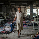 Textile Worker Walking Through Abandoned Factory