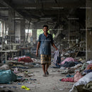 Man Walking Through Abandoned Textile Factory