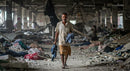 Man Walking Through Rubble in a Derelict Building