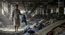 Man Walking Through Debris in Abandoned Building