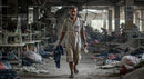 Worker Walking Through Abandoned Textile Factory