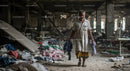Desolate Garment Factory Interior with Lone Worker