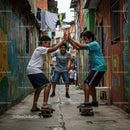 Boys Having Fun Skateboarding in a Colorful Alley