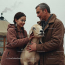 Couple in Warm Attire with Friendly Goat in Rural Setting