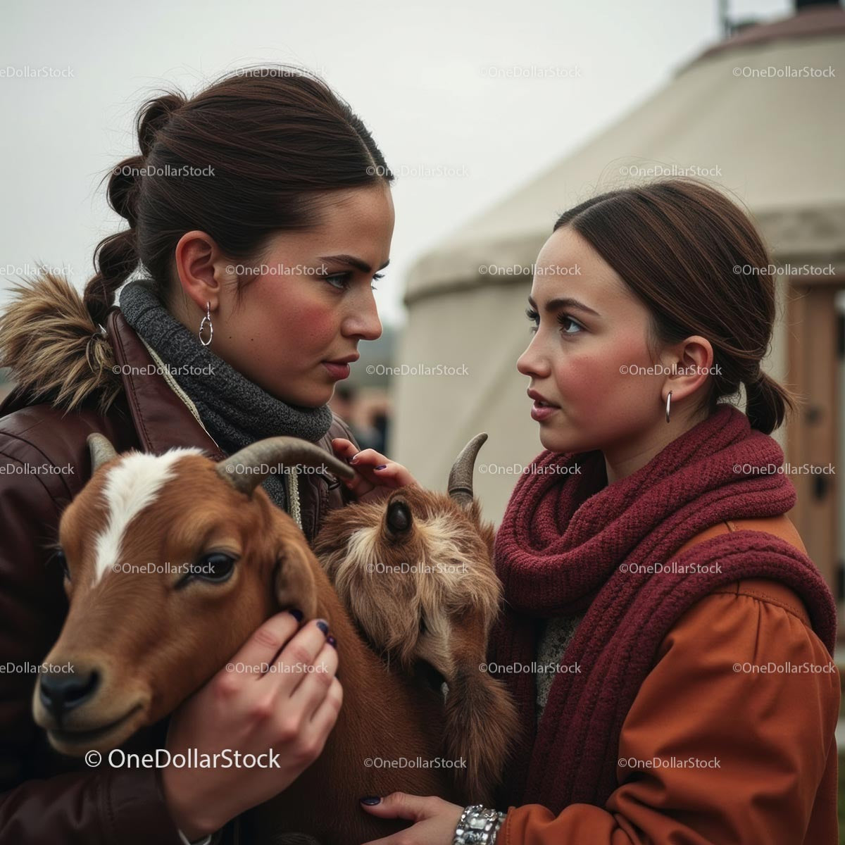 Two Women in Warm Clothes Holding Goats Outdoors