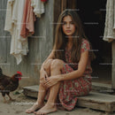Young Woman in Floral Dress with Farm Chicken
