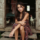 Young Woman Relaxing on Wooden Porch with Chickens