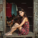 Young Woman in Floral Dress Sitting in Rustic Doorway