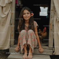 Girl with Flower Relaxing in Rustic Countryside Setting