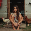 Young Woman Sitting at Barn Door with Chickens