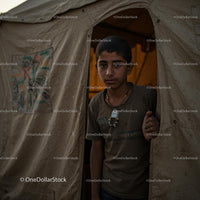 Boy Gazing Out from Canvas Tent Entrance