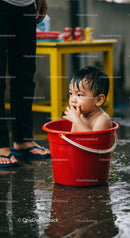 Cute Baby Enjoying Splash Time in a Red Bucket