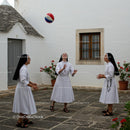 Nuns Enjoying a Game in a Courtyard Setting