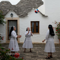 Nuns Playing with a Ball in a Charming Courtyard