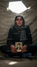 Emotional Portrait of Woman Holding Photo in Shelter