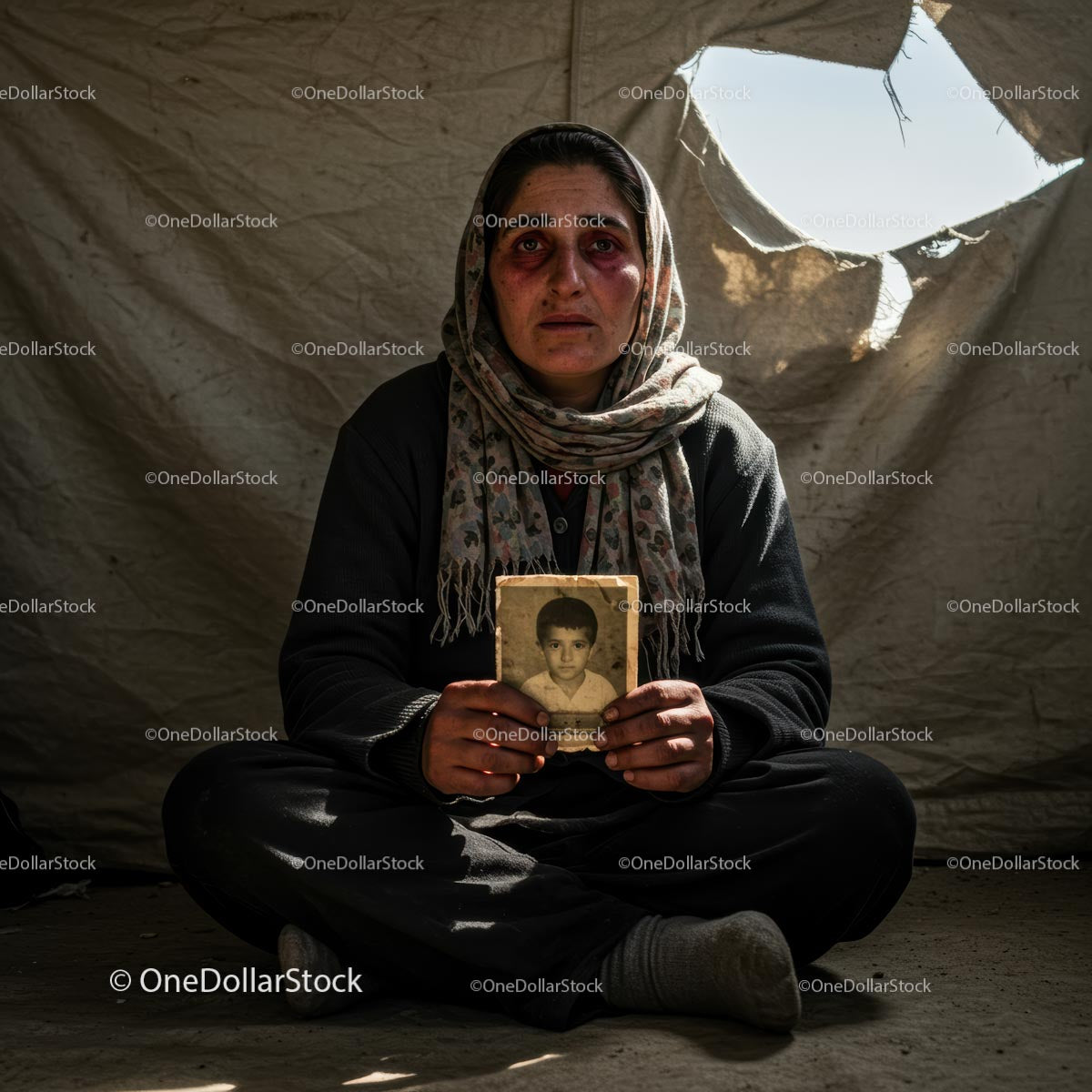 Portrait of a Woman with a Child's Photograph in a Refugee Tent