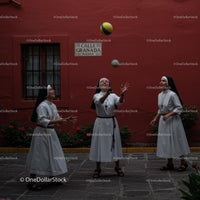 Joyful Nuns Juggling in a Vibrant Urban Setting