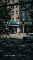 Urban Street View with Blurred Motion and Fence Foreground