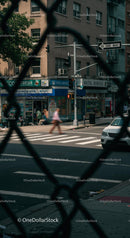 Busy City Intersection Captured Through Fence