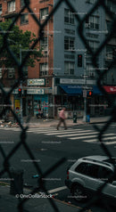 Urban Street Scene Through Chain Link Fence
