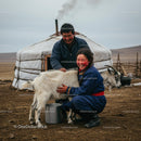 Smiling Mongolian Family with Goat by Traditional Yurt